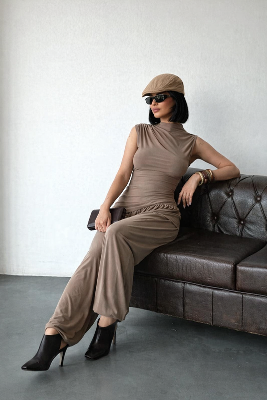 Black Sienna Drape Set two-piece outfit with draped sleeveless top and wide-leg pants styled with luxury accessories.