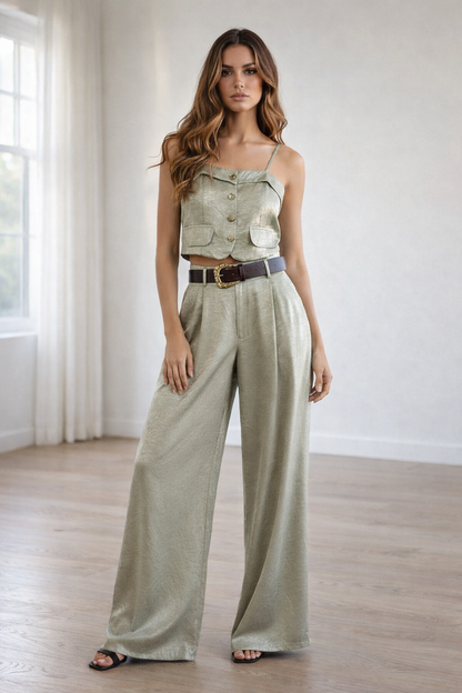 olive green linen outfit set with spaghetti strap cropped top and flowy wide leg pants, styled with a brown belt and black heels.