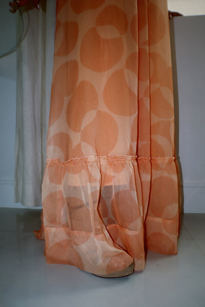 Peach lightweight halter maxi dress with a relaxed fit and flowing fabric photographed near a poolside setting